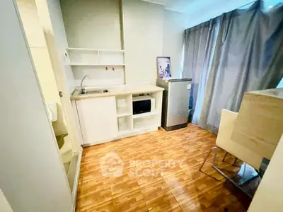 Cozy kitchen with modern appliances and wooden flooring in a bright apartment