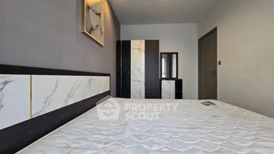 Modern bedroom with stylish decor and comfortable mattress in a contemporary apartment.