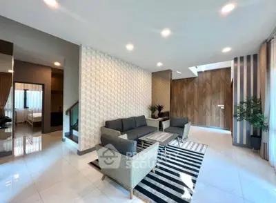 Spacious modern living room with stylish decor and ample natural light