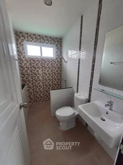 Modern bathroom with stylish tiles and natural light
