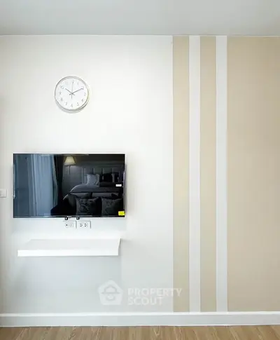 Modern living room with wall-mounted TV and stylish decor