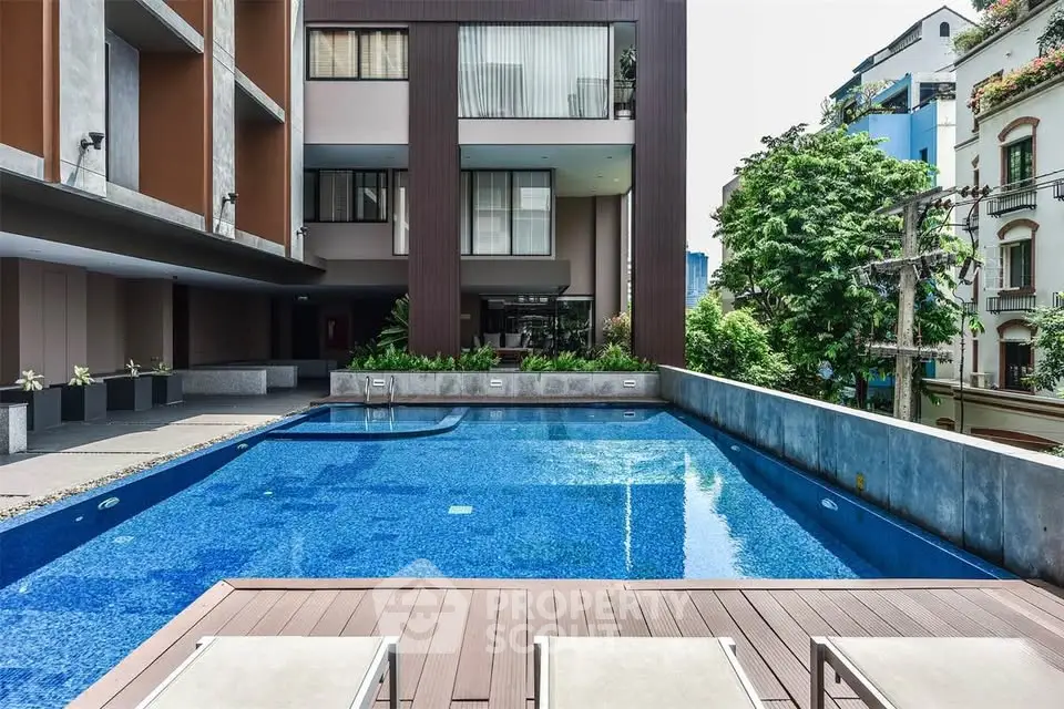 Luxurious apartment complex with stunning outdoor pool and modern architecture.
