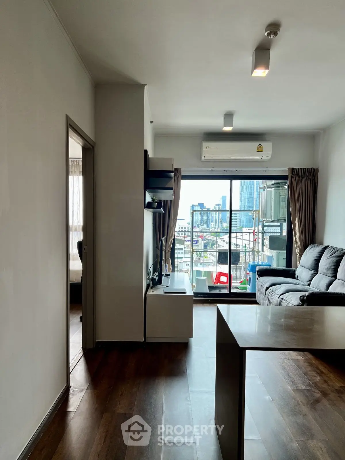 Modern living room with city view and sleek furnishings