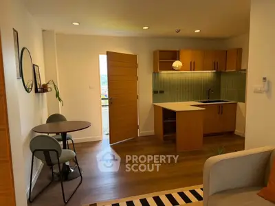 Modern open-layout kitchen with stylish dining area and wooden flooring