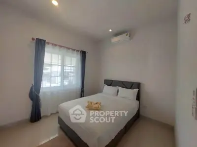 Cozy bedroom with modern air conditioning and natural light