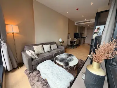 Modern living room with cozy decor and stylish furniture in a high-rise apartment.