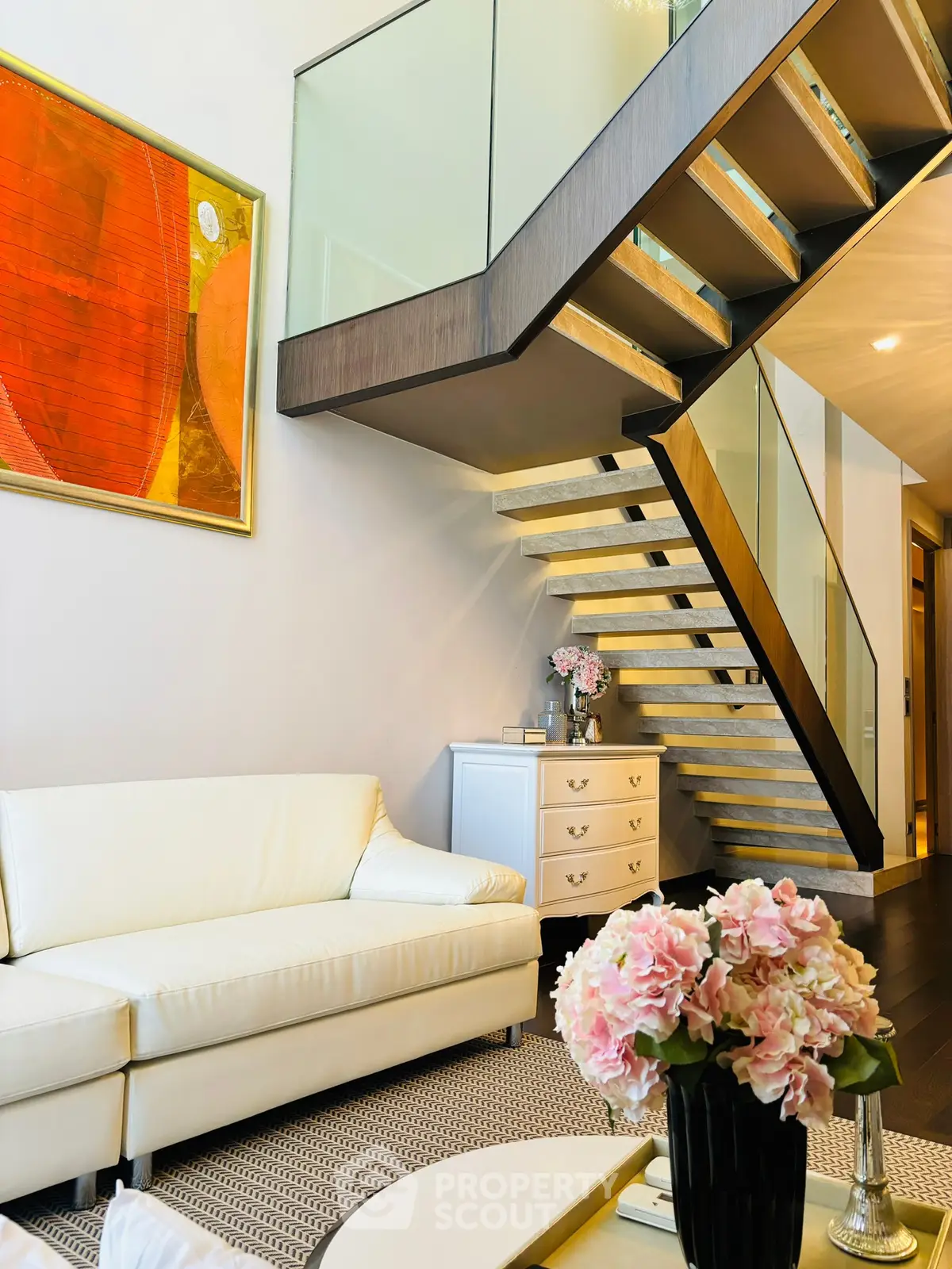 Modern living room with elegant staircase and stylish decor