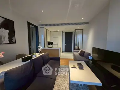Modern living room with sleek furniture and open kitchen layout
