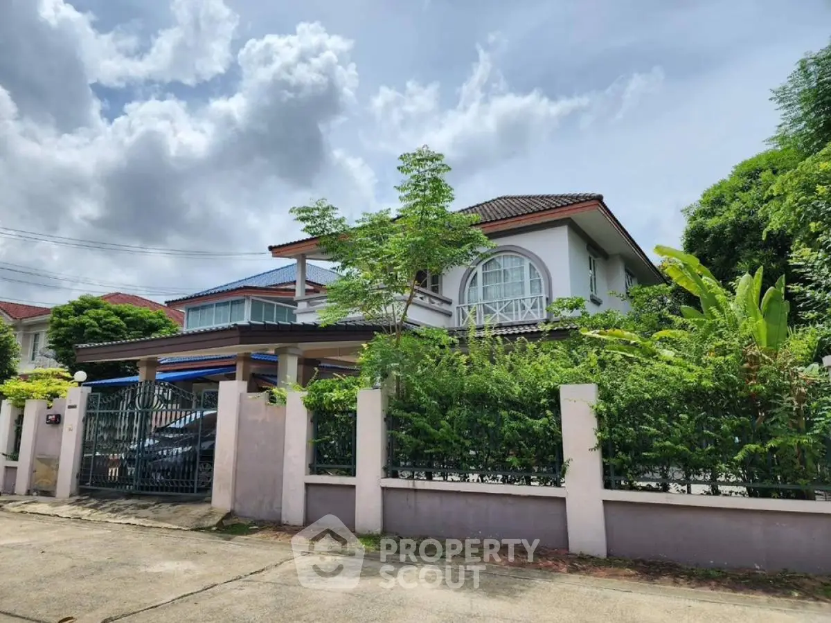 Charming two-story house with lush garden and spacious driveway in serene neighborhood.