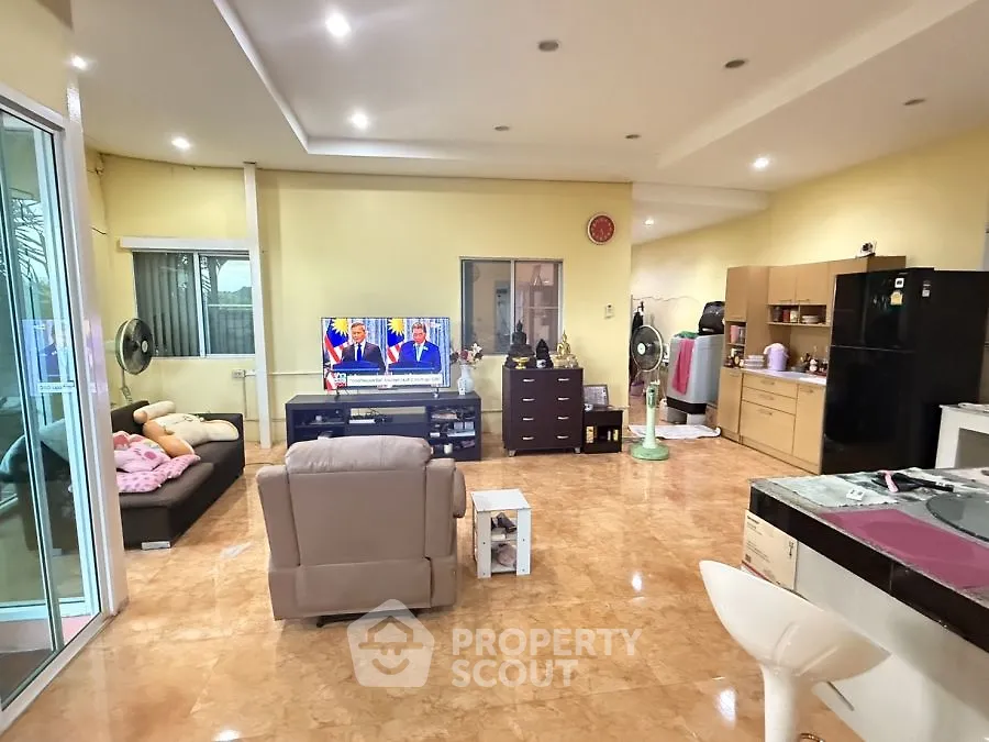 Spacious living room with modern furniture and open kitchen layout
