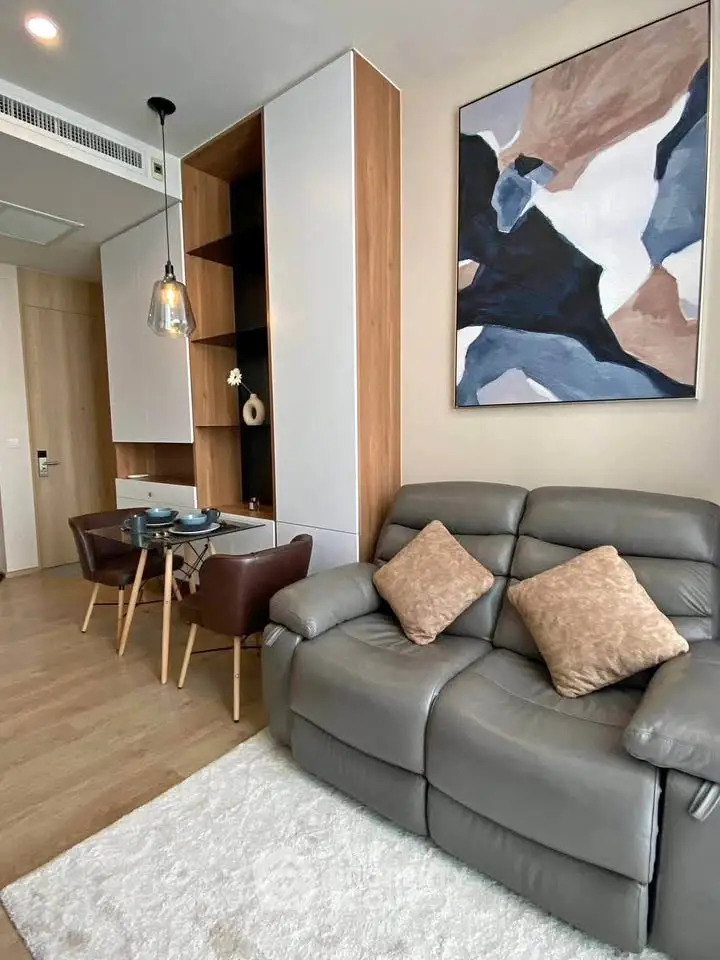 Modern living room with stylish decor, cozy seating, and elegant dining area in a contemporary apartment.
