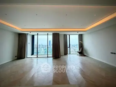 Spacious modern living room with panoramic city view and elegant lighting.