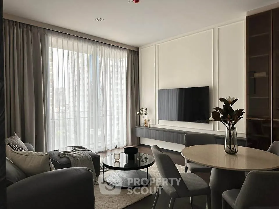 Modern living room with elegant decor and large window offering city view