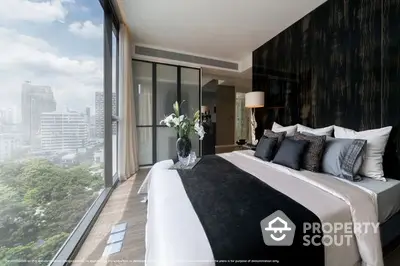 Luxurious bedroom with floor-to-ceiling windows offering a panoramic city view, elegantly furnished with a plush king-sized bed and modern decor.