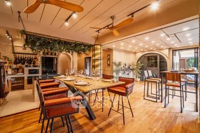 Luxurious open-concept kitchen and dining area with modern decor and warm lighting.