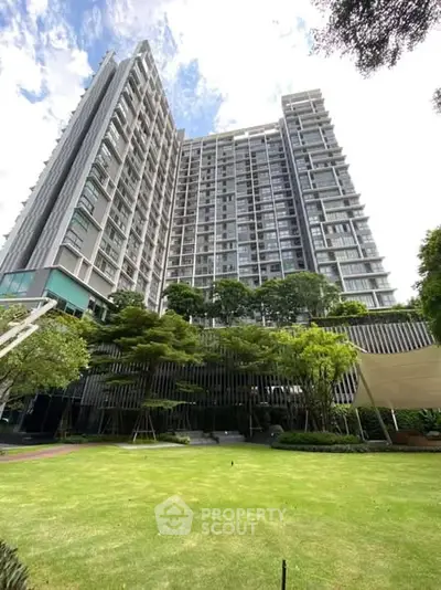 Stunning high-rise building with lush garden view, perfect for urban living.