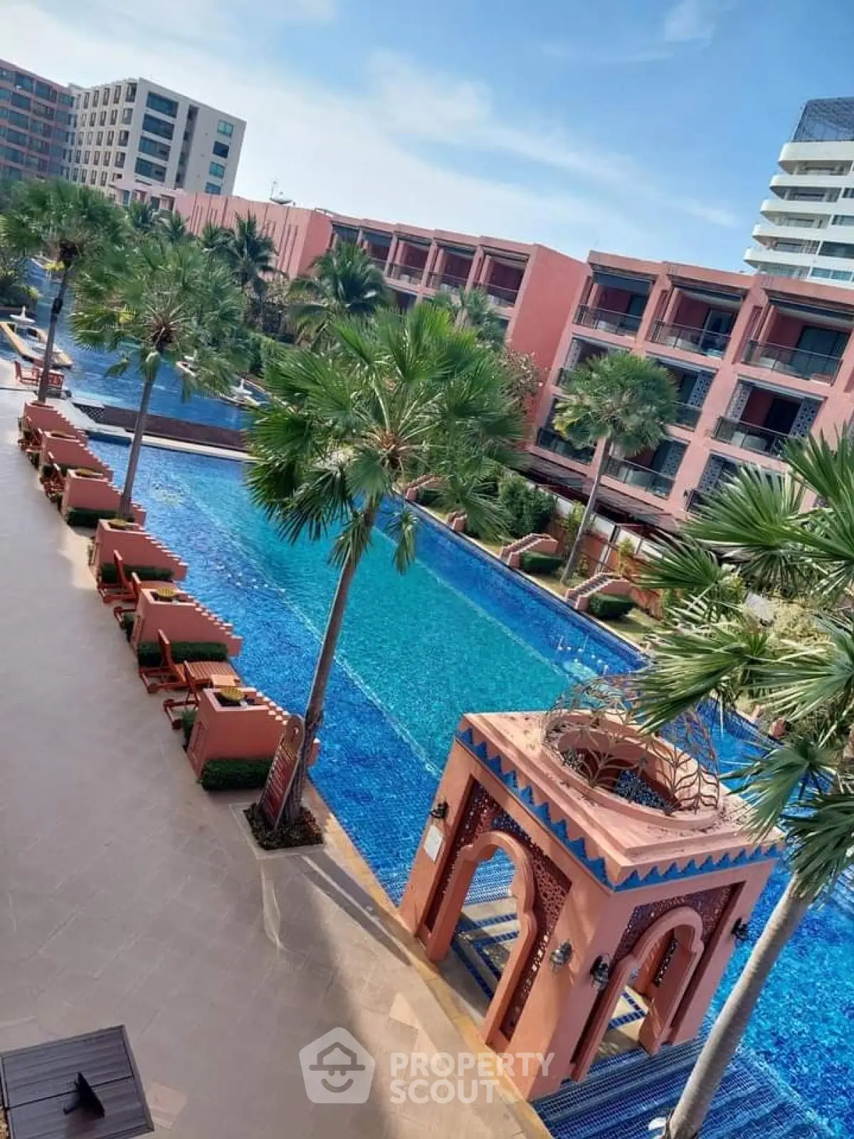 Luxurious resort-style pool with palm trees and elegant architecture
