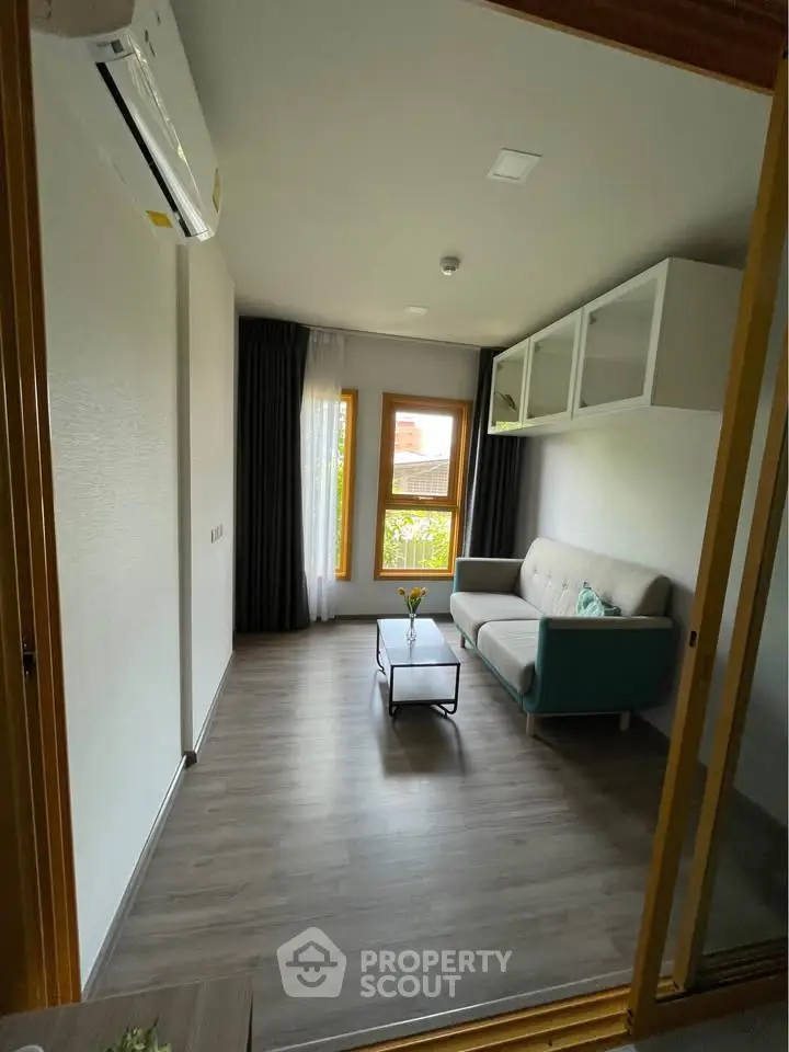 Modern living room with sleek design and large window view