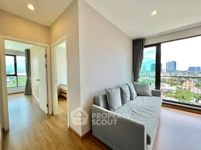 Modern living room with city view and cozy sofa in bright apartment