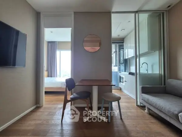 Modern apartment interior with open layout, featuring a cozy living area and sleek kitchen.