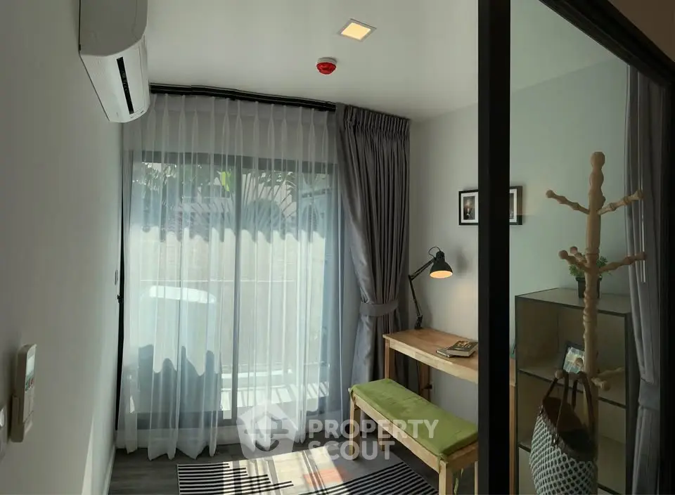 Cozy study room with natural light, modern decor, and air conditioning.