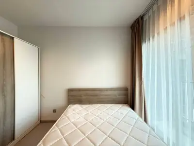 Modern bedroom with minimalist design and large window for natural light
