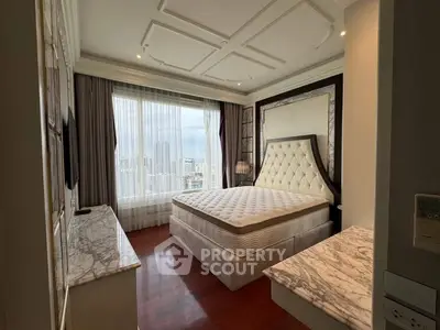 Luxurious bedroom with city view, elegant decor, and plush furnishings