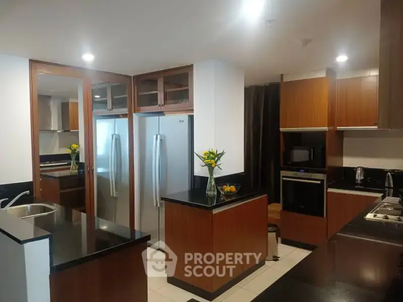 Modern kitchen with sleek black countertops and stainless steel appliances
