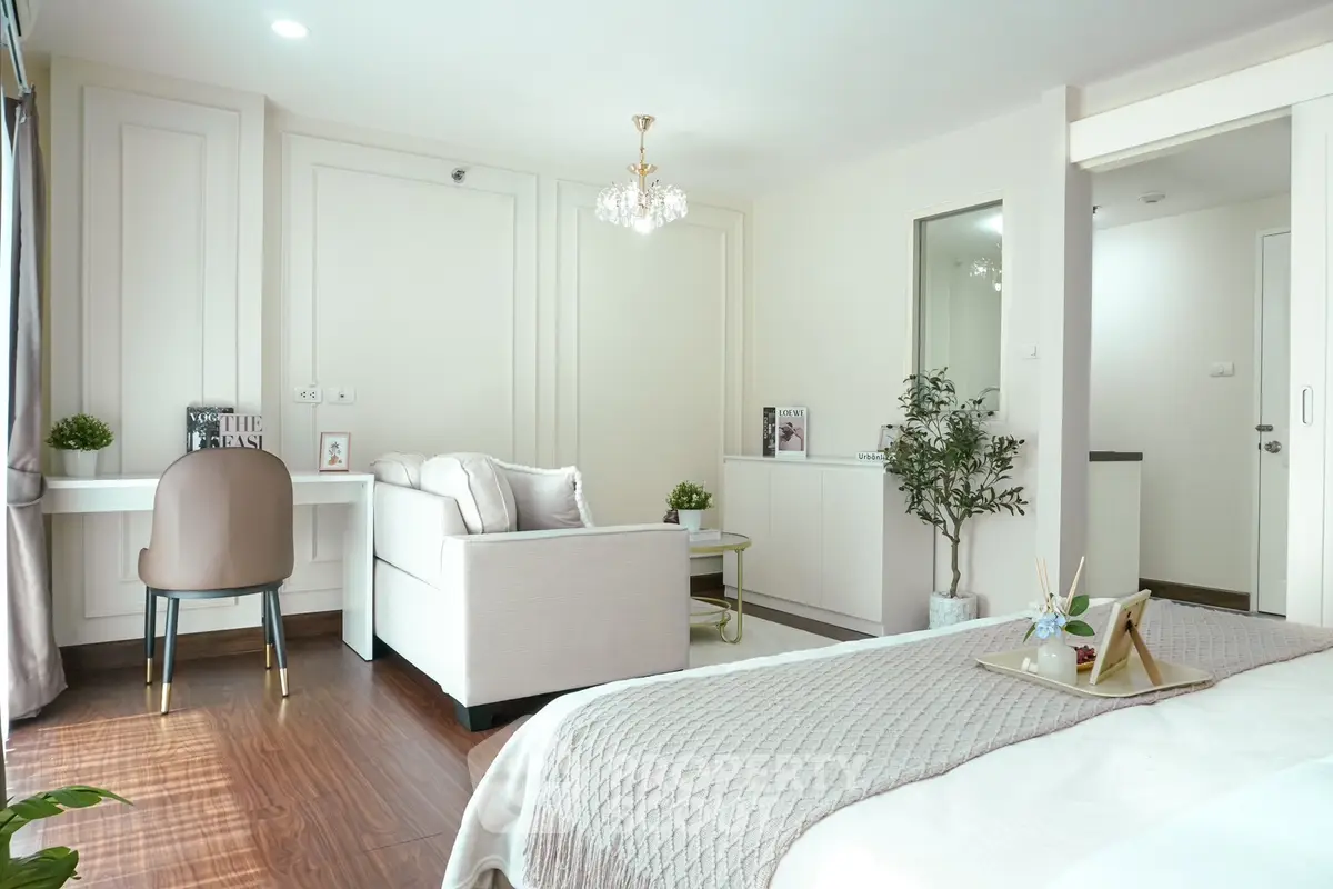 Luxurious bedroom with elegant decor and cozy seating area, perfect for relaxation.