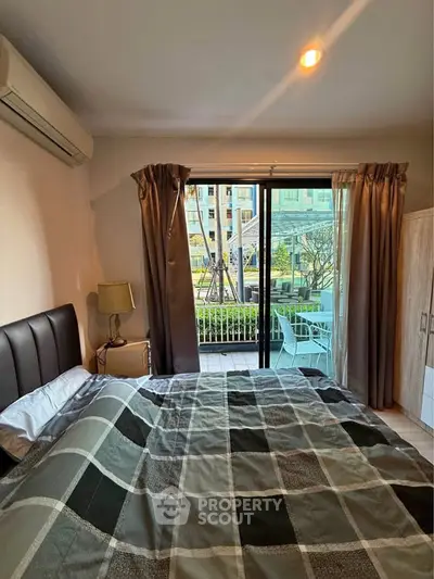 Cozy bedroom with balcony access and garden view in modern apartment