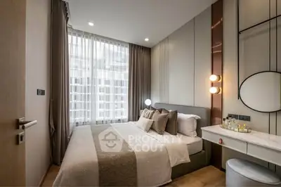 Modern bedroom with elegant decor and large window offering natural light.