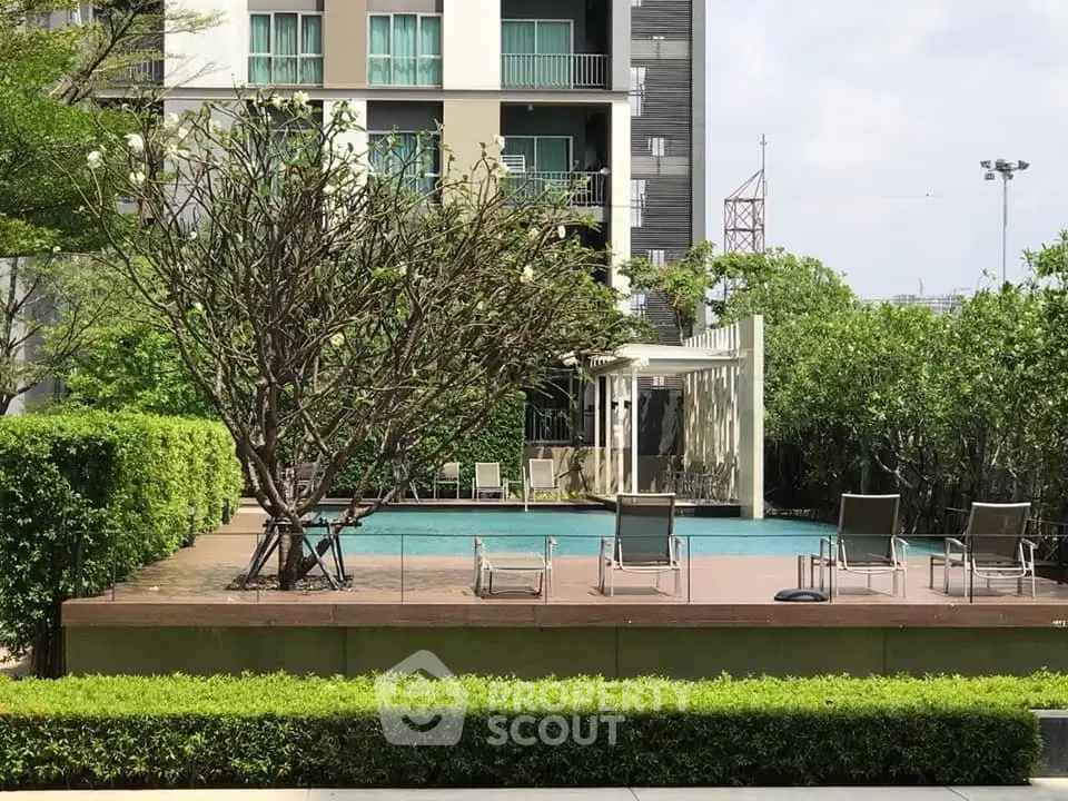 Luxurious apartment complex with serene poolside and lush greenery