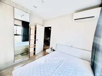 Modern bedroom with mirrored wardrobe and air conditioning in a bright apartment