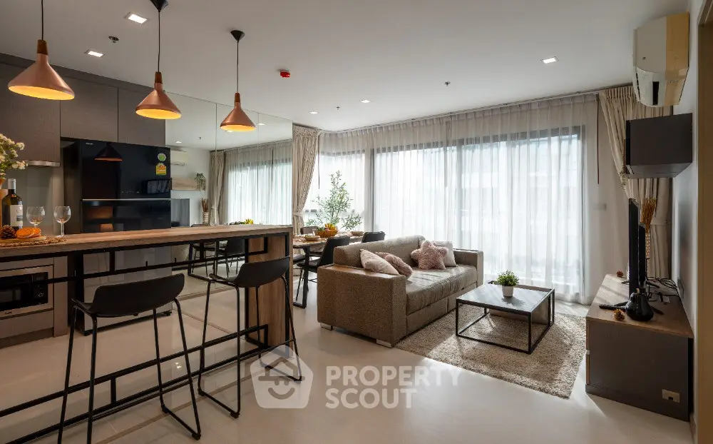 Modern open-plan living room with stylish kitchen and cozy seating area