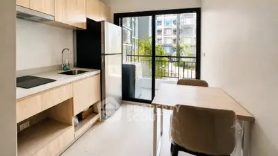 Modern kitchen with open layout and balcony view in a stylish apartment.