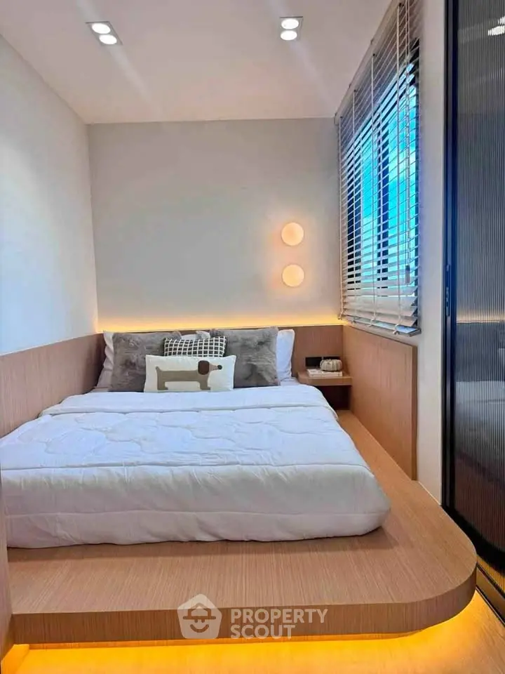 Modern minimalist bedroom with platform bed and ambient lighting
