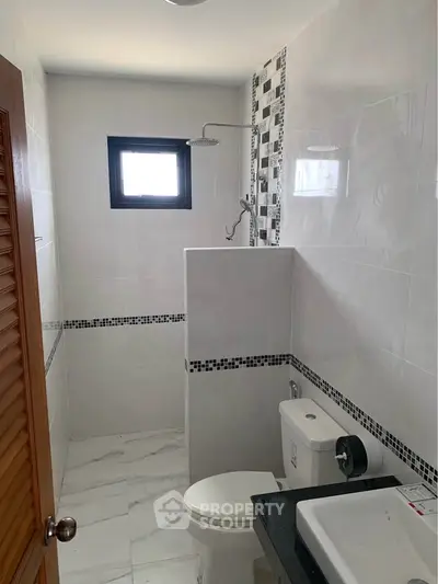 Modern bathroom with sleek tiles and walk-in shower