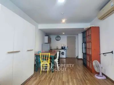 Charming open-plan living area with colorful dining set and modern appliances.