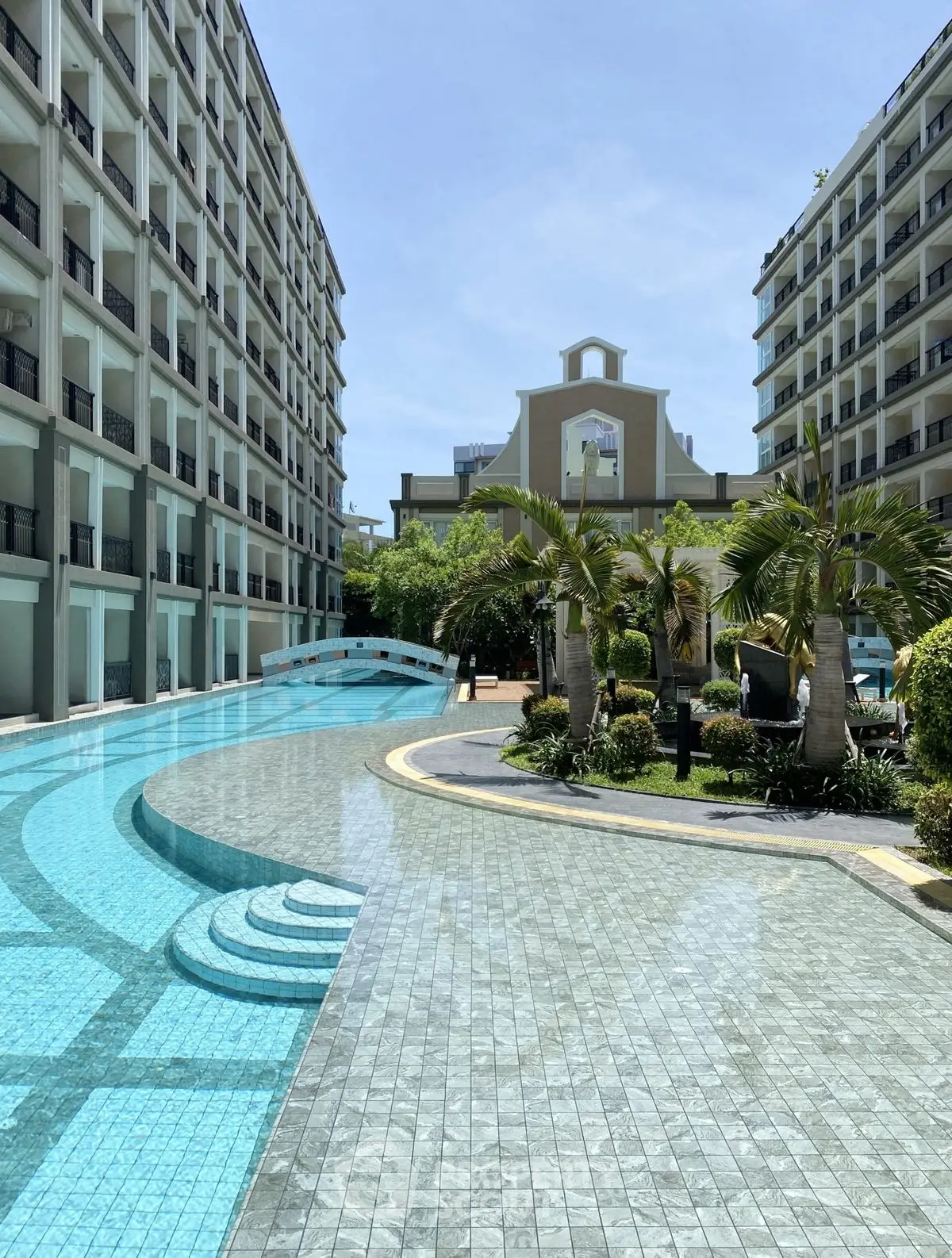 Luxurious resort-style pool area with modern architecture and lush greenery
