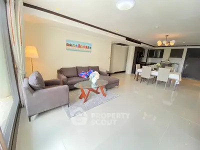 Spacious modern living room with elegant dining area and large windows.