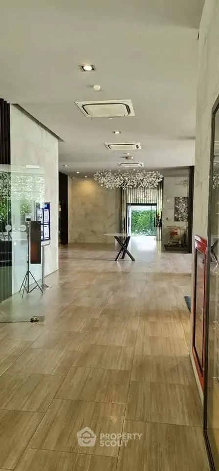 Elegant building entrance with modern decor and ample natural light