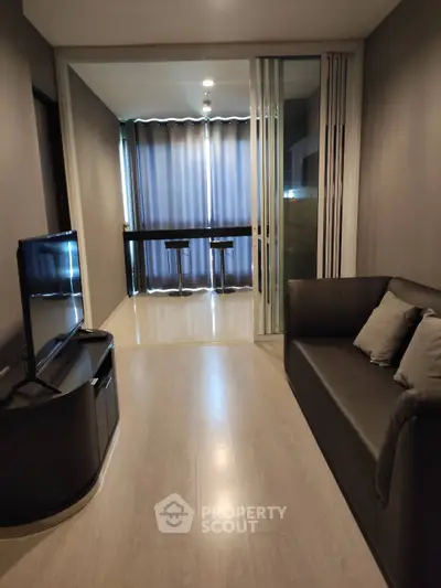 Modern living room with sleek furniture and floor-to-ceiling windows