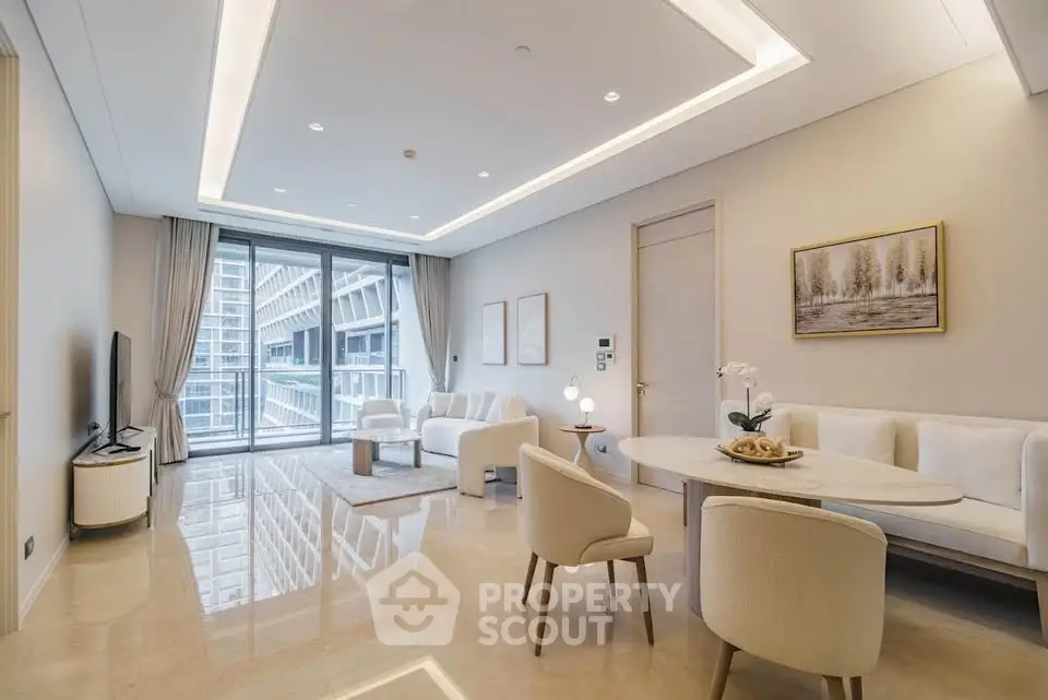 Luxurious modern living room with elegant decor and stunning city view from large windows.