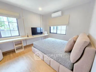 Modern bedroom with large windows and stylish decor