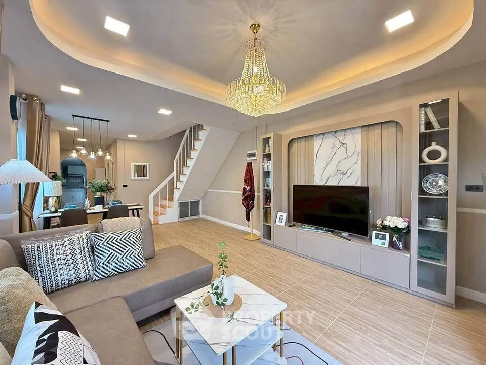 Luxurious modern living room with elegant chandelier and stylish decor