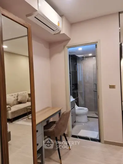 Modern apartment interior with study area and bathroom view