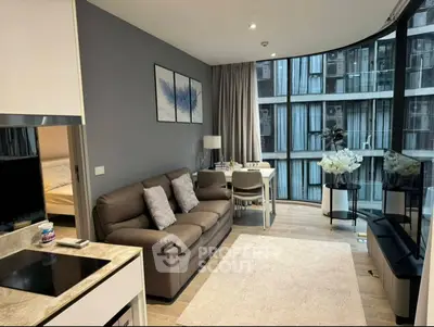 Modern living room with large windows and stylish decor in a contemporary apartment.