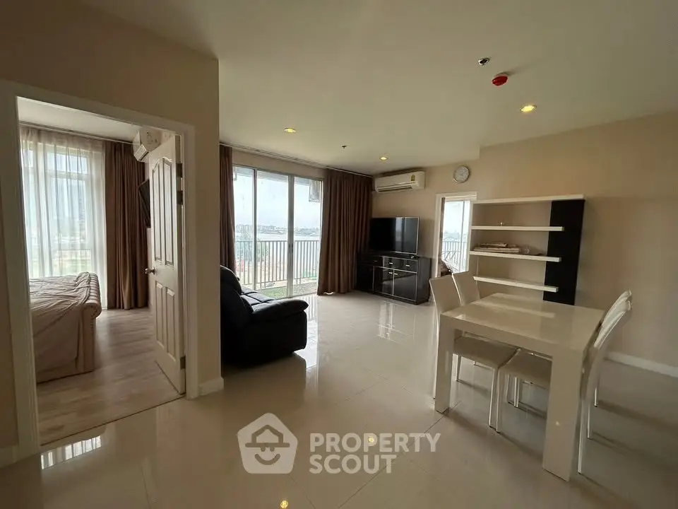 Spacious modern living room with open layout and large windows offering natural light.