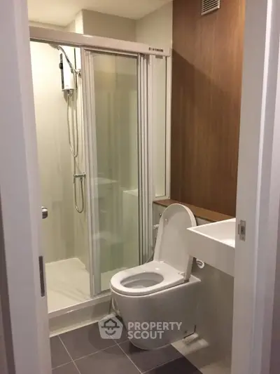 Modern bathroom with sleek shower and contemporary fixtures in a stylish apartment.