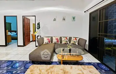 Charming living room with stylish sofa and glass coffee table, perfect for relaxation and entertaining.